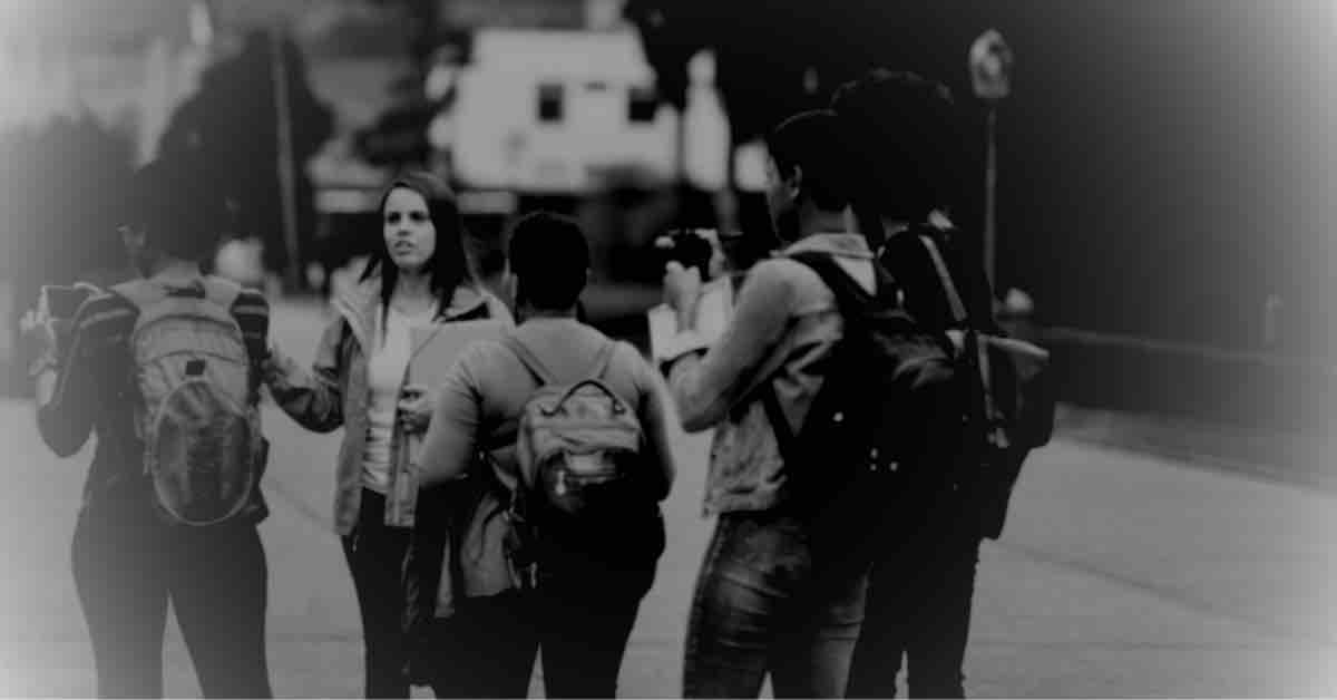 A guide leading a group through a dimly lit street on a haunted ghost walk.