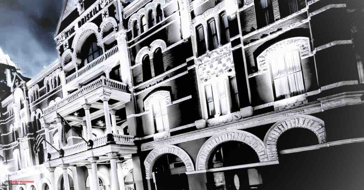 Exterior view of the haunted Driskill Hotel Austin TX, showcasing its historic architecture and eerie ambiance at twilight.