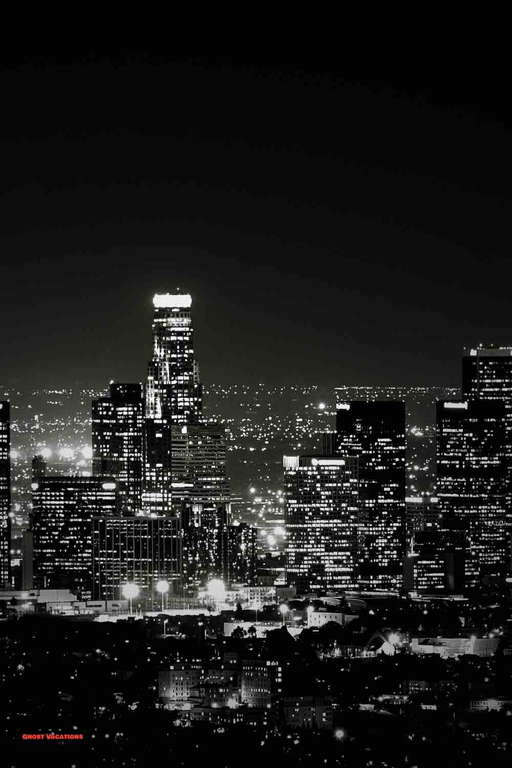 Nighttime LA skyline featuring iconic landmarks and the city's haunted Los Angeles hotels, where ghost stories and urban legends come to life.