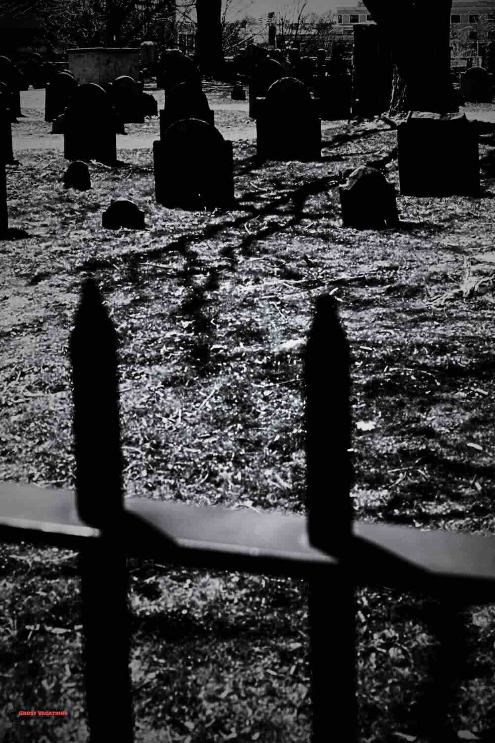 "Eerie twilight at Charles Street Cemetery, a key stop on Salem ghost tours."