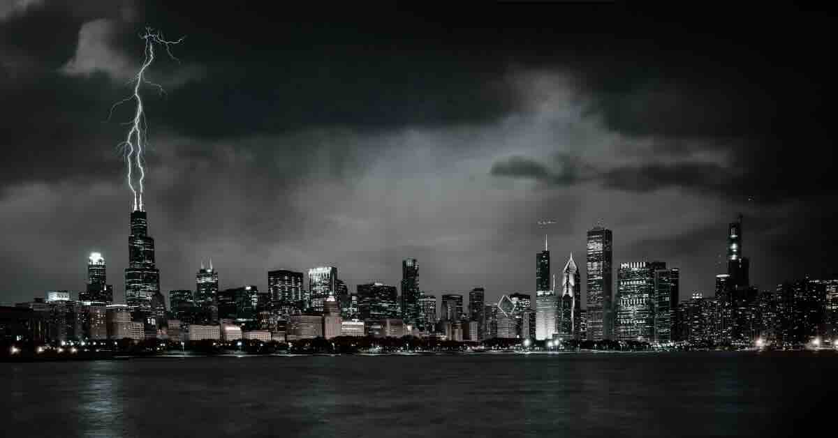 Chicago skyline reflecting over Lake Michigan at twilight, capturing the city's landmarks explored in ghost tours in Chicago.